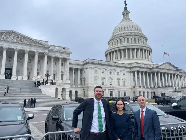 Ryan Brown, Jennifer Smith, and Danniel Topple standing outside the Capitol Building in Washington DC