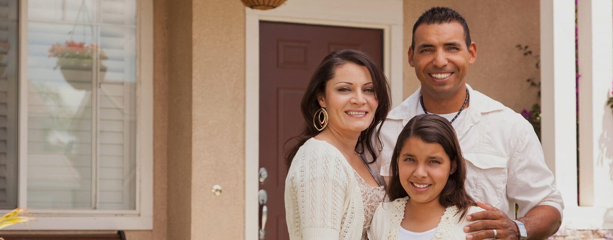 Family in front of house