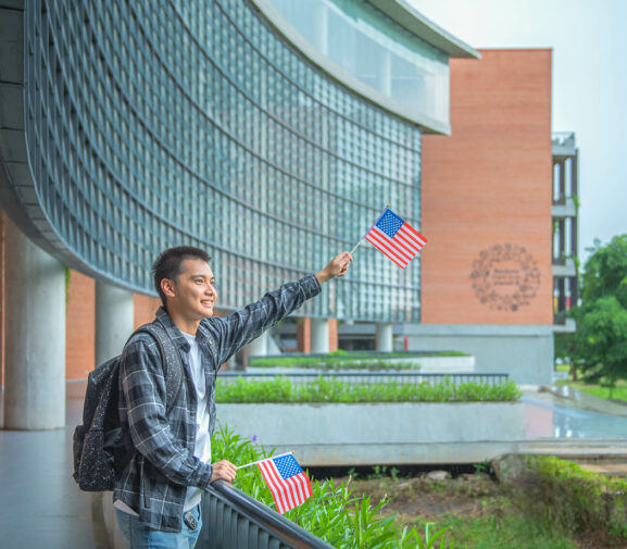 Asian Man waiving american flag